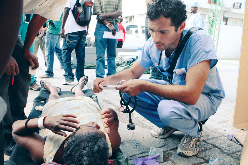 Emergency medical physician Ayman S. Yassa treating a Haitian woman after earthquake