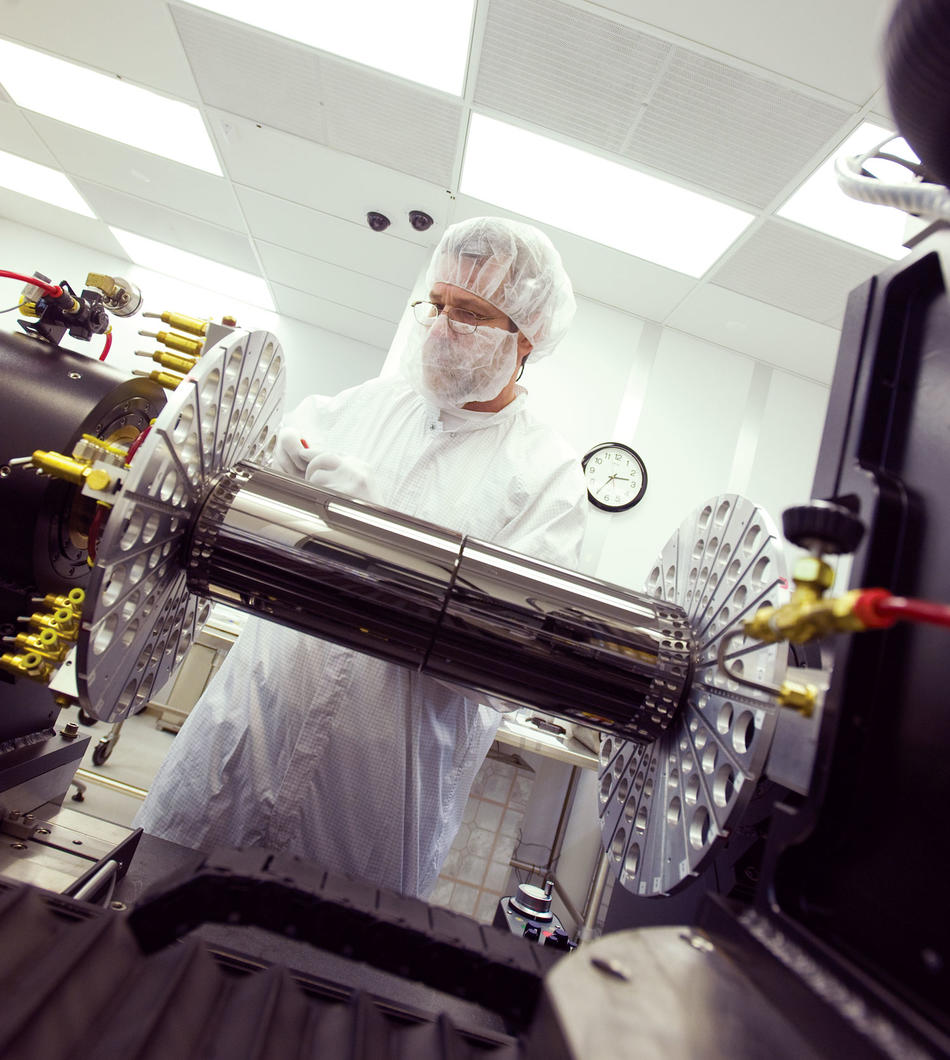 Chuck Hailey with telescope piece in lab