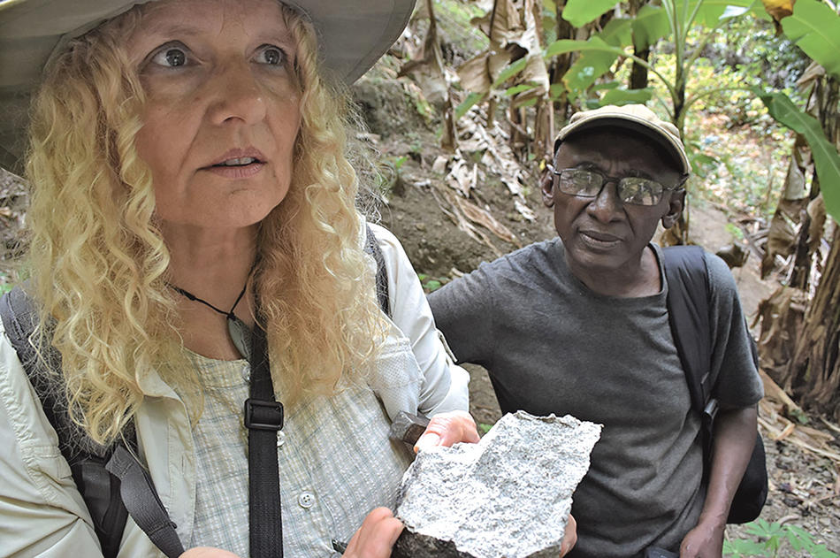 Cornelia Class and archaeologist Bourhane Abderemane inspecting a chunk of quartzite on Anjouan 