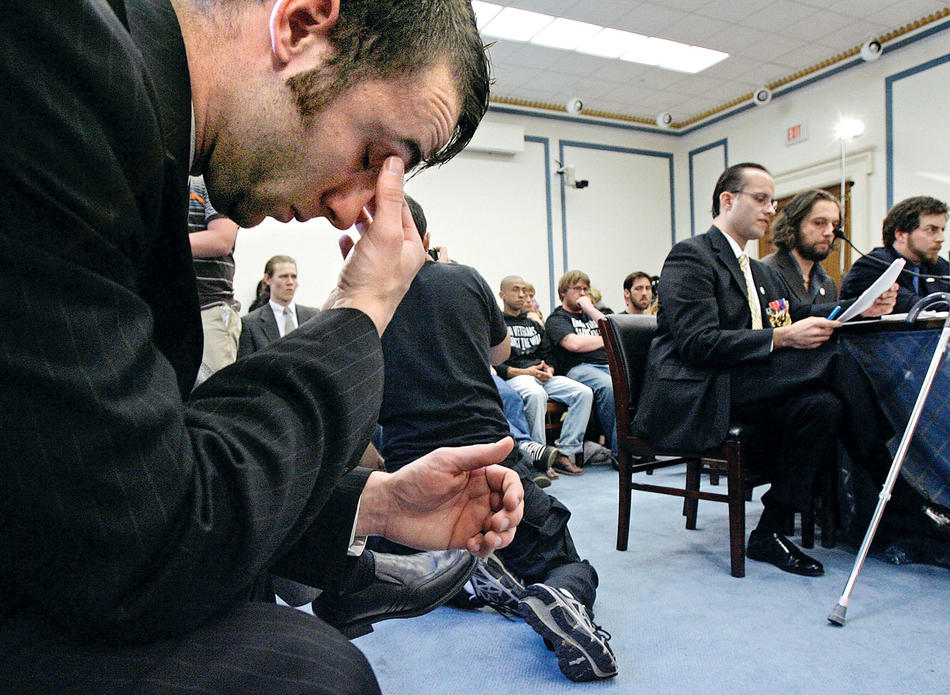 Former U.S. Army Sgt. Kristofer Goldsmith, who was denied GI Bill benefits because he attempted suicide, listens to fellow members of the Iraq Veterans Against the War testify before Congress in 2008