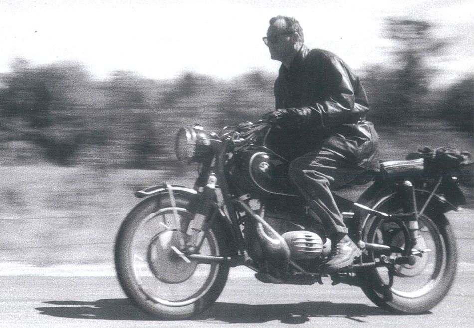 C. Wright Mills riding a BMW motorcycle in 1958