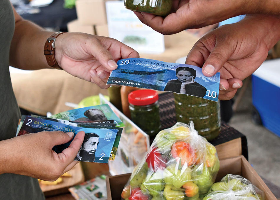 People exchanging "Pesos of Puerto Rico" as part of Columbia professor Frances Negrón-Muntaner's "Valor y Cambio" project