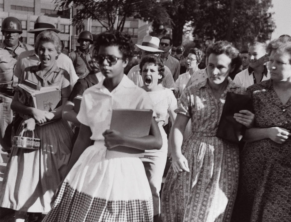 Elizabeth Eckford walking to enroll at Little Rock Central High School in 1957, with mob of white protesters yelling