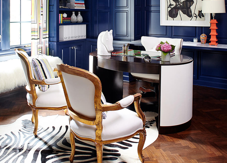 A desk and chairs in a room painted blue