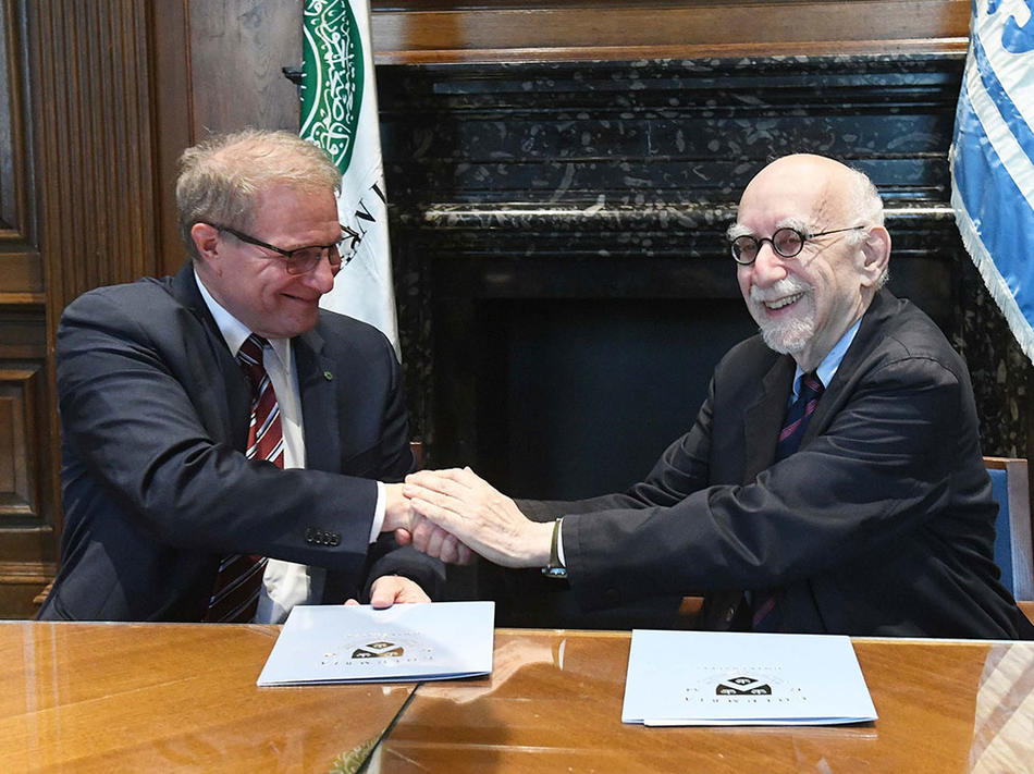 Carl Amrhein (left), Provost of Aga Khan University, shakes hands with Ira Katznelson, Columbia’s Interim Provost