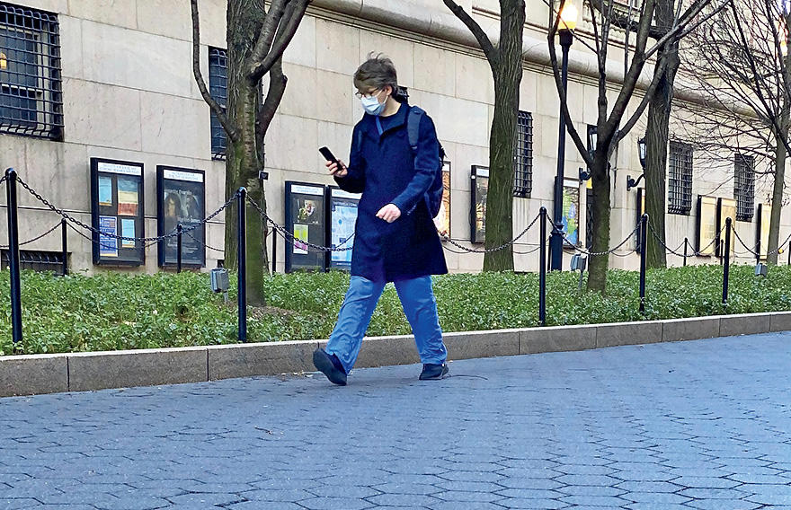 A person walking on Columbia campus in a face mask during COVID-19 shutdown