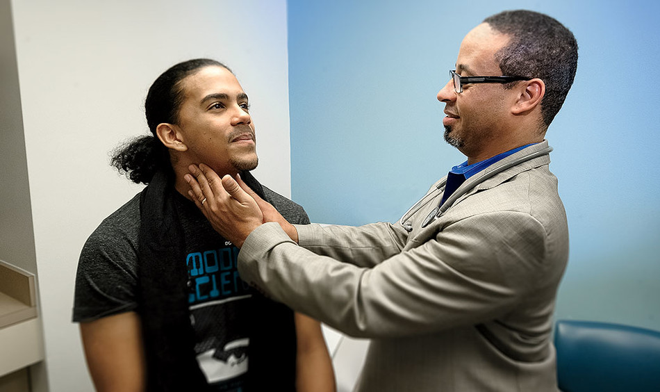 Physician David Louis Bell treats a patient at CUIMC