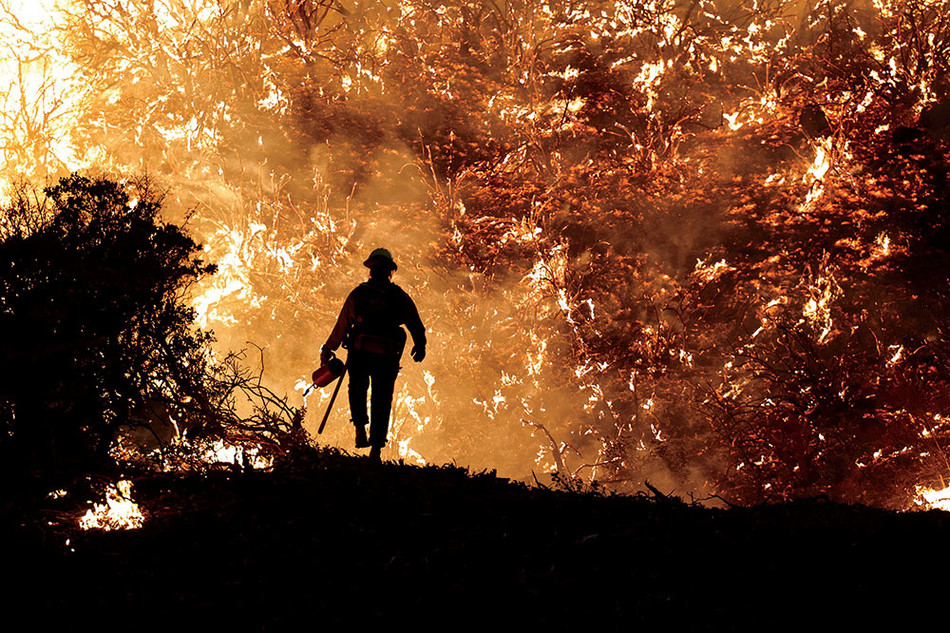 A firefighter battles the Caldor Fire in Grizzly Flats, California in 2021