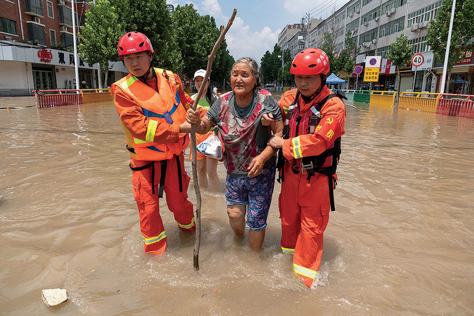 Rescue workers helping a flood victim in China’s Henan Province in July 2021