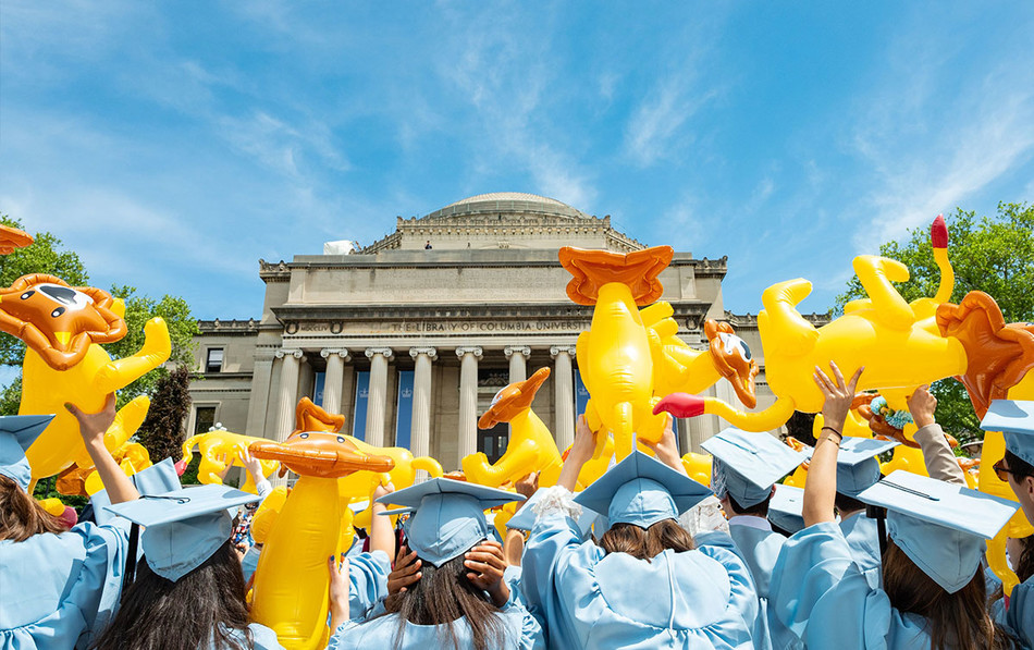 Columbia College graduates waving inflatable Roar-ee lions on 2022 Commencement Day