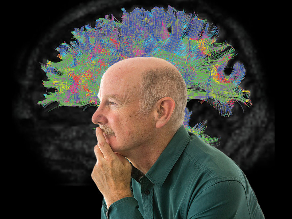 Rafael Yuste in front of a brain image