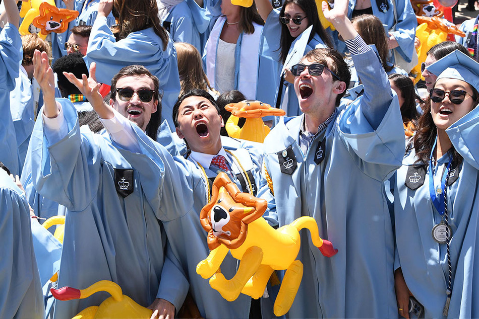 Columbia College graduates with inflatable lions at Columbia University's 2023 commencement ceremony
