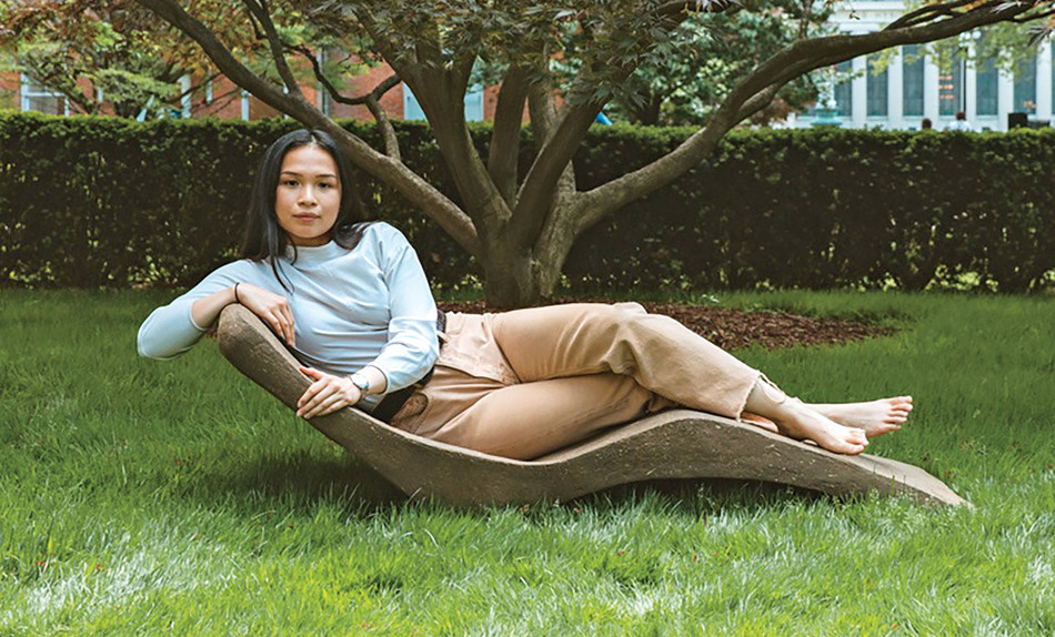 Woman sitting in a biodegradable, low-carbon chair made by Columbia's Natural Materials Lab
