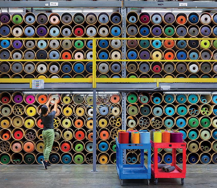 Spools of yarn, which designers use to create custom carpet-tile prototypes and samples, at Interface, LaGrange, Georgia.