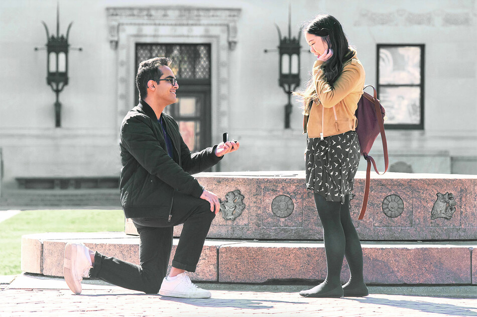 A couple gets engaged next to Columbia University sundial 