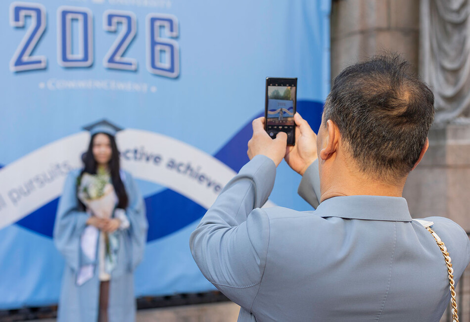 A Columbia graduate getting her photo taken at 2026 commencement