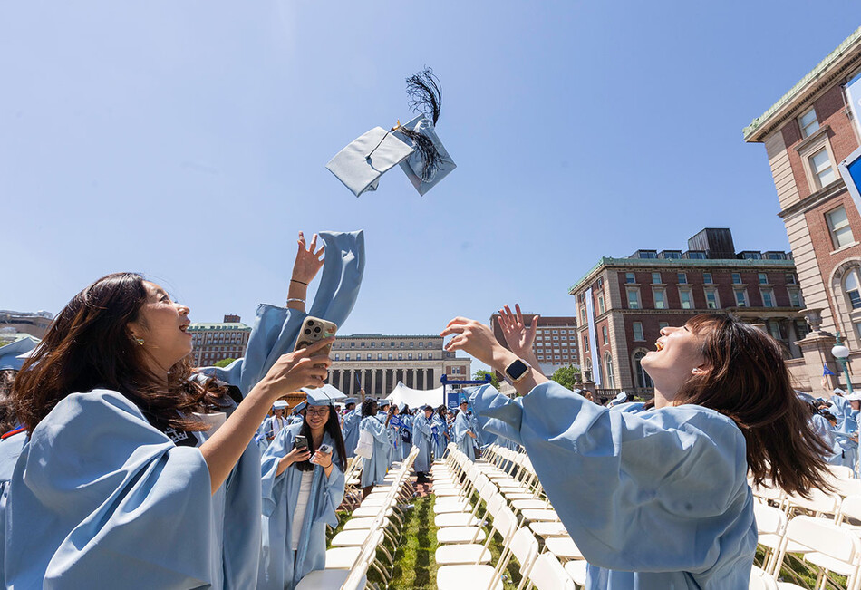 Graduates throwing their caps into the air at 2026 Columbia Commencement