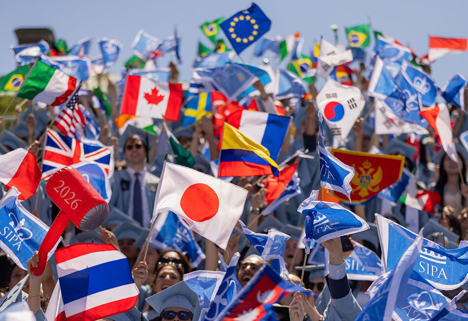 Columbia SIPA grad waiving flags at commencement 2026