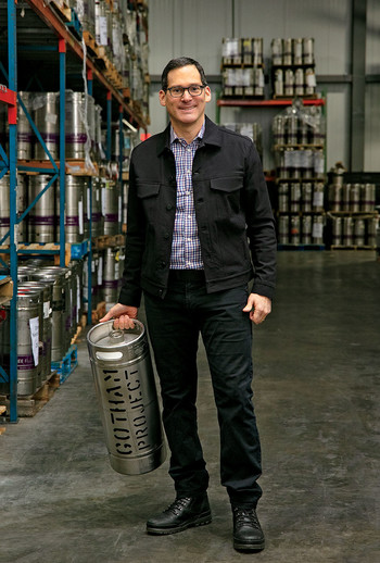 Bruce Schneider holding a keg of Gotham Wine Project wine